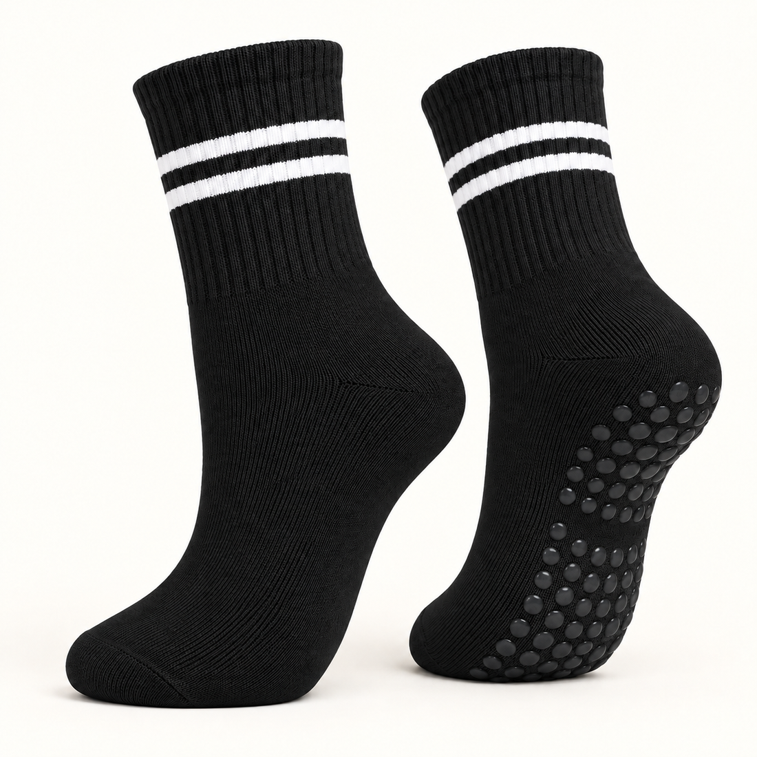 Black striped Pilates grip socks, angled pair showing the grip dots