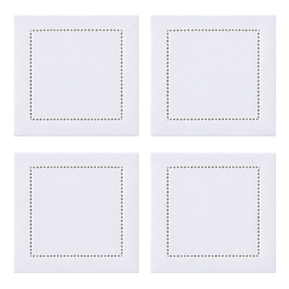 Set of four white hemstitch cocktail napkins in a two-by-two grid, blank and ready for personalization